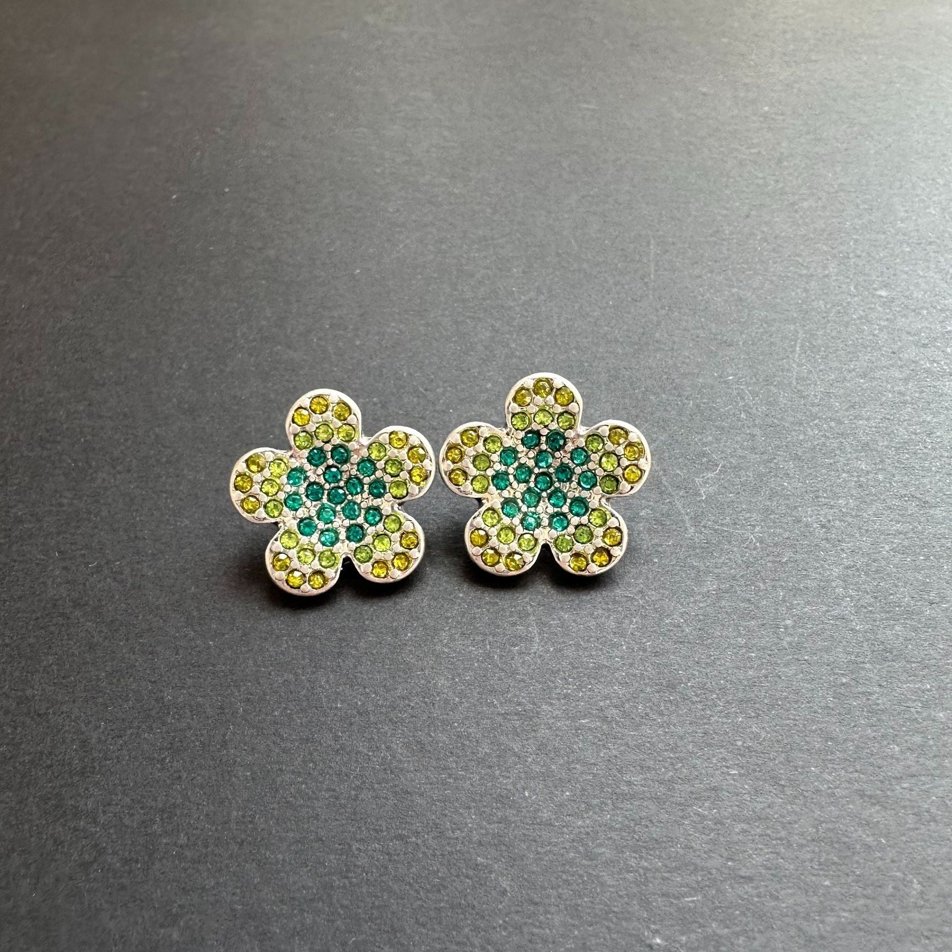 Gold-tone floral stud earrings with green and teal rhinestones