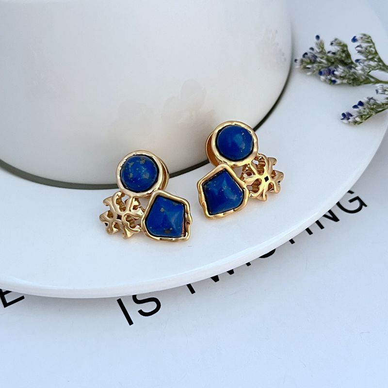Gold-tone multi-stone stud earrings with blue acrylic discs and square stones