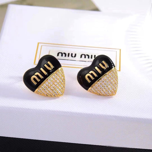 Heart stud earrings with black enamel top and gold-tone pavé bottom, gold logo