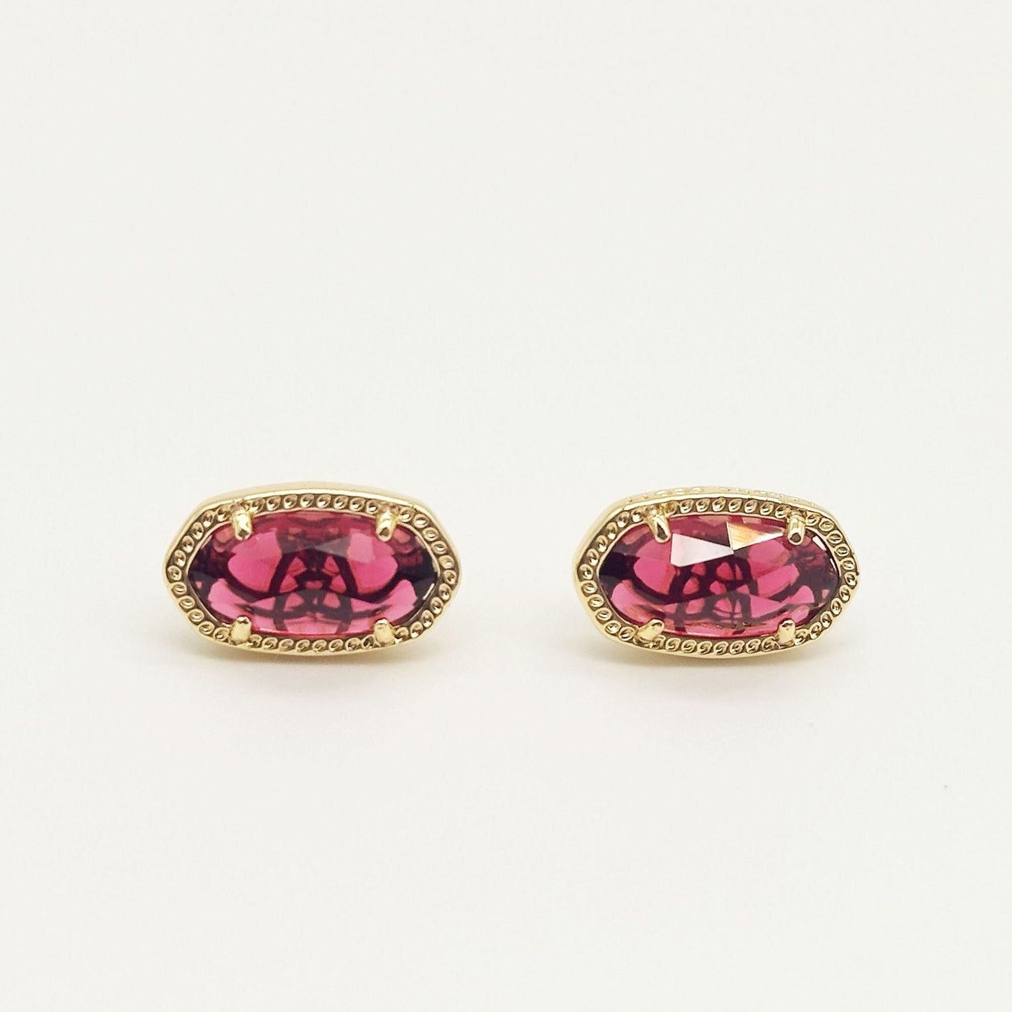 Kendra Scott oval gemstone stud earrings with magenta crystal in gold bezel setting