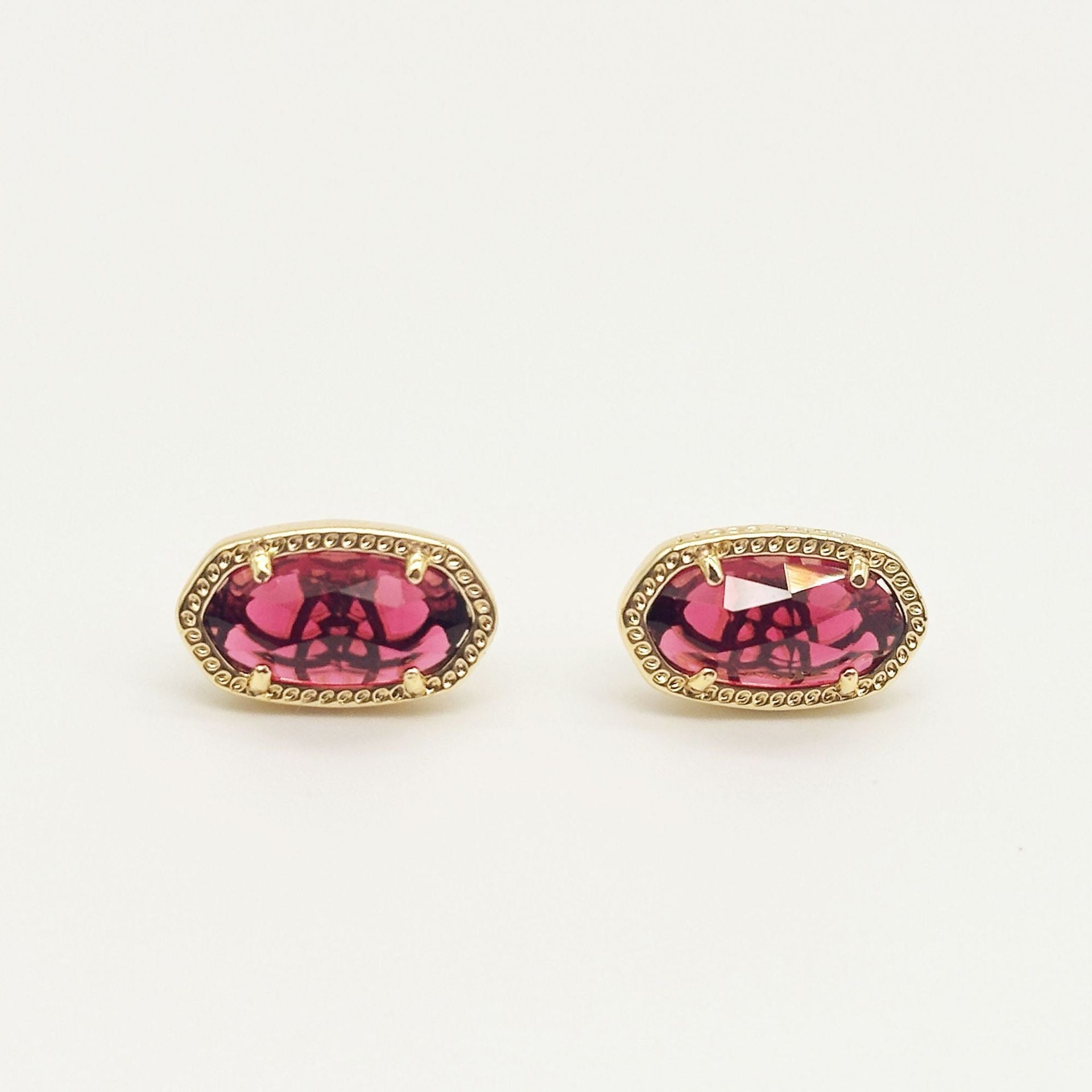 Kendra Scott oval gemstone stud earrings with magenta crystal in gold bezel setting