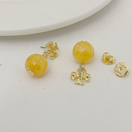 Round yellow agate bead earrings with gold logo charm and post back