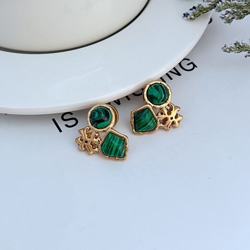 Gold-tone multi-stone stud earrings with dark green acrylic discs and striped squares