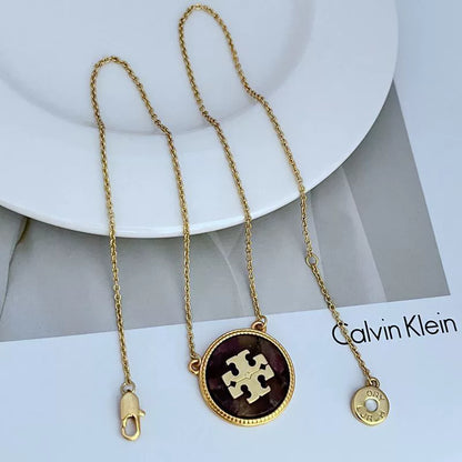 Gold-tone circle coin pendant necklace with purple round enamel charm and small toggle clasp