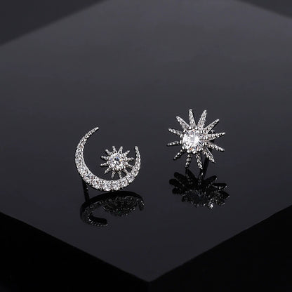 Moon and star diamond stud earrings, silver-tone crescent with starburst details