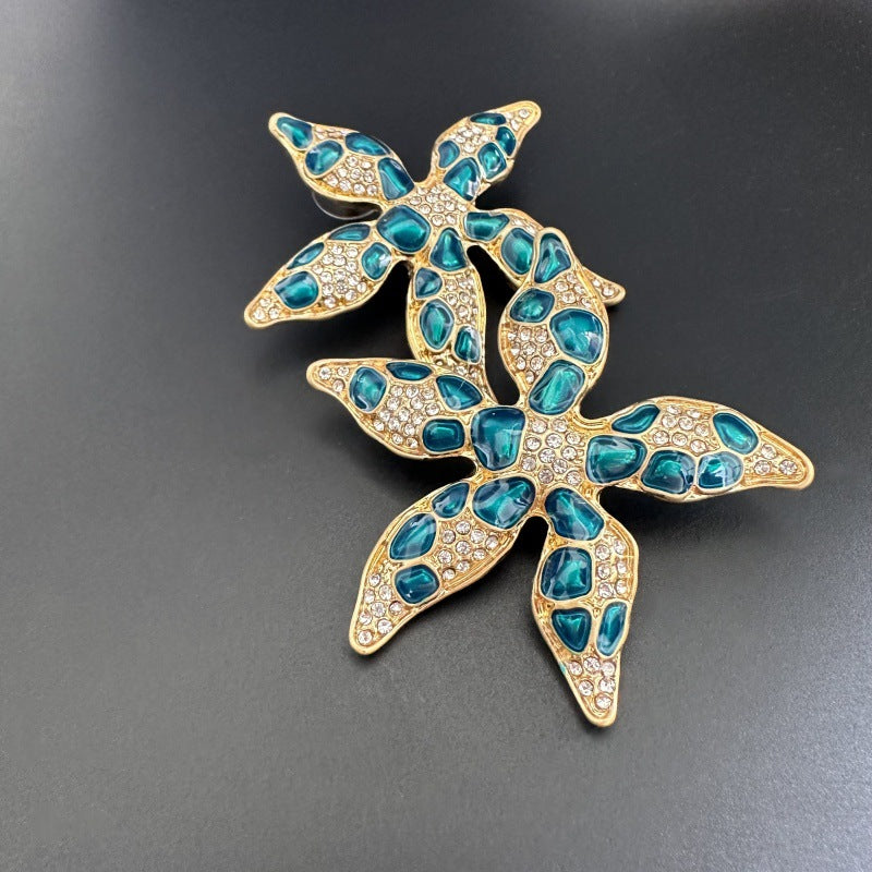 Starfish flower earrings with blue enamel jelly-spots and gold-tone rhinestones
