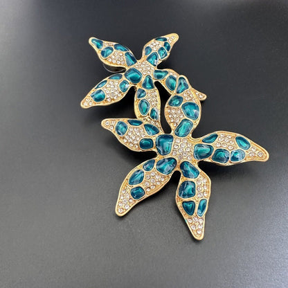 Starfish flower earrings with blue enamel jelly-spots and gold-tone rhinestones