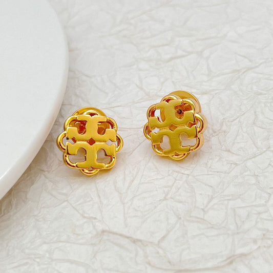 Gold tone openwork floral logo stud earrings with round cutout design