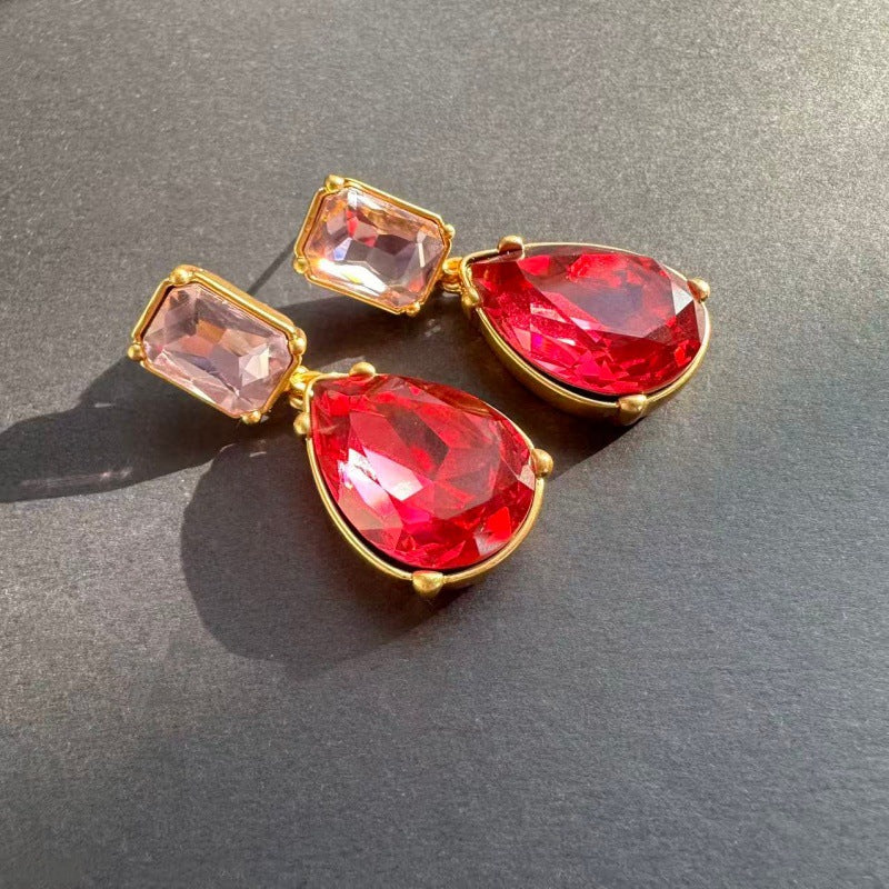 Teardrop-cut diamond stud earrings with red teardrop stones and pink-red square studs, gold-tone