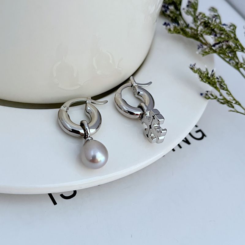 Silver asymmetrical pearl hoop earrings with dangling white pearl and charm detail