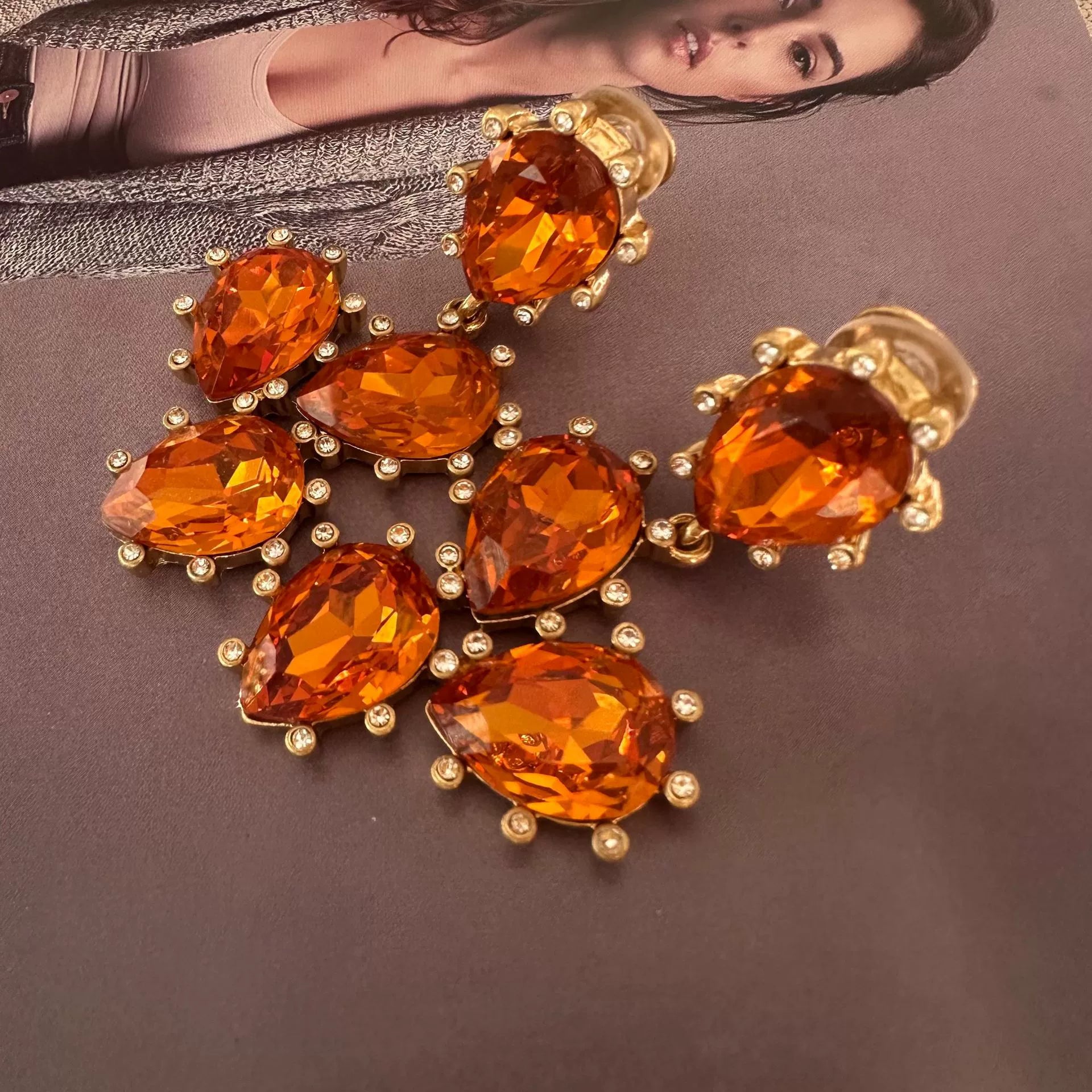 Cactus-cut glass ear clips with amber-orange stones and gold-tone prong setting