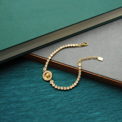 Gold-tone beaded bracelet with round coin clover charm and clasp