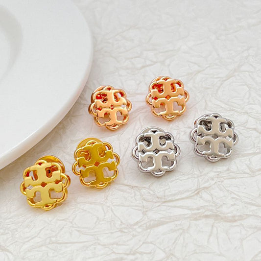 Assorted openwork floral logo stud earrings in gold and silver tones, round cutouts