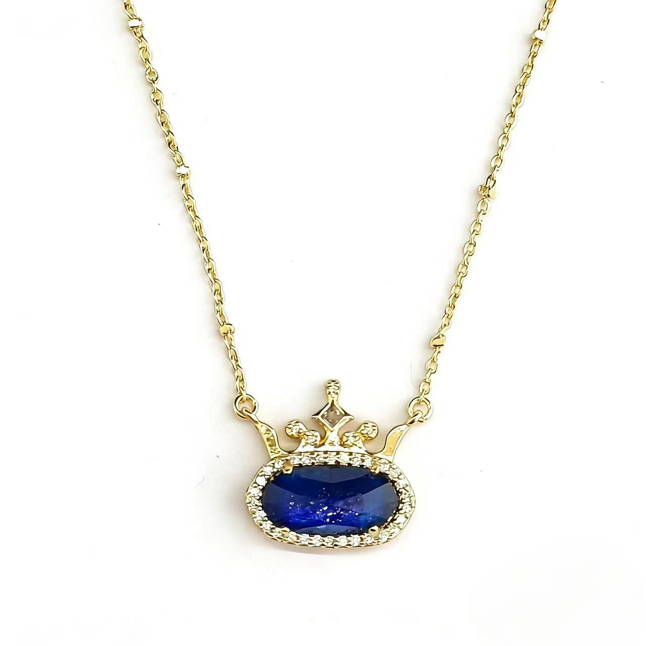 Gold-plated princess crown necklace with blue oval gemstone and diamond-style halo