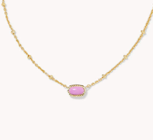 Gold-tone necklace with small oval pink gemstone pendant on a fine chain.