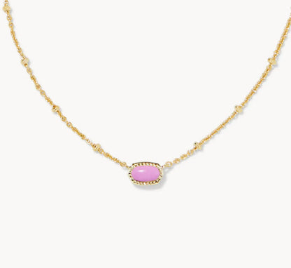 Gold-tone necklace with small oval pink gemstone pendant on a fine chain.