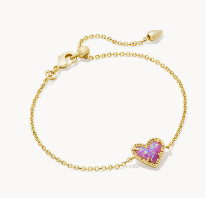 Adjustable heart charm bracelet with gold-tone chain and iridescent purple heart crystal pendant.