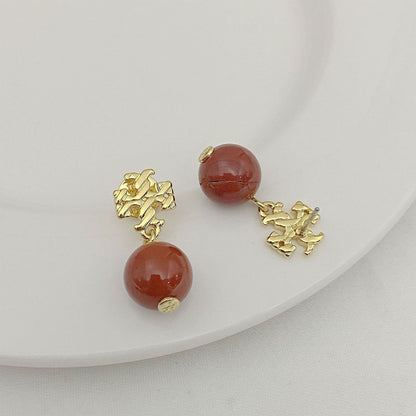 Agate pendant earrings with round red beads and gold-toned textured pendant connectors