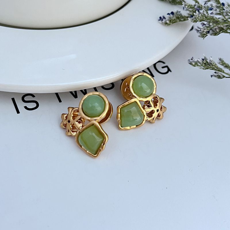 Gold-tone multi-stone stud earrings with green acrylic discs and square charms
