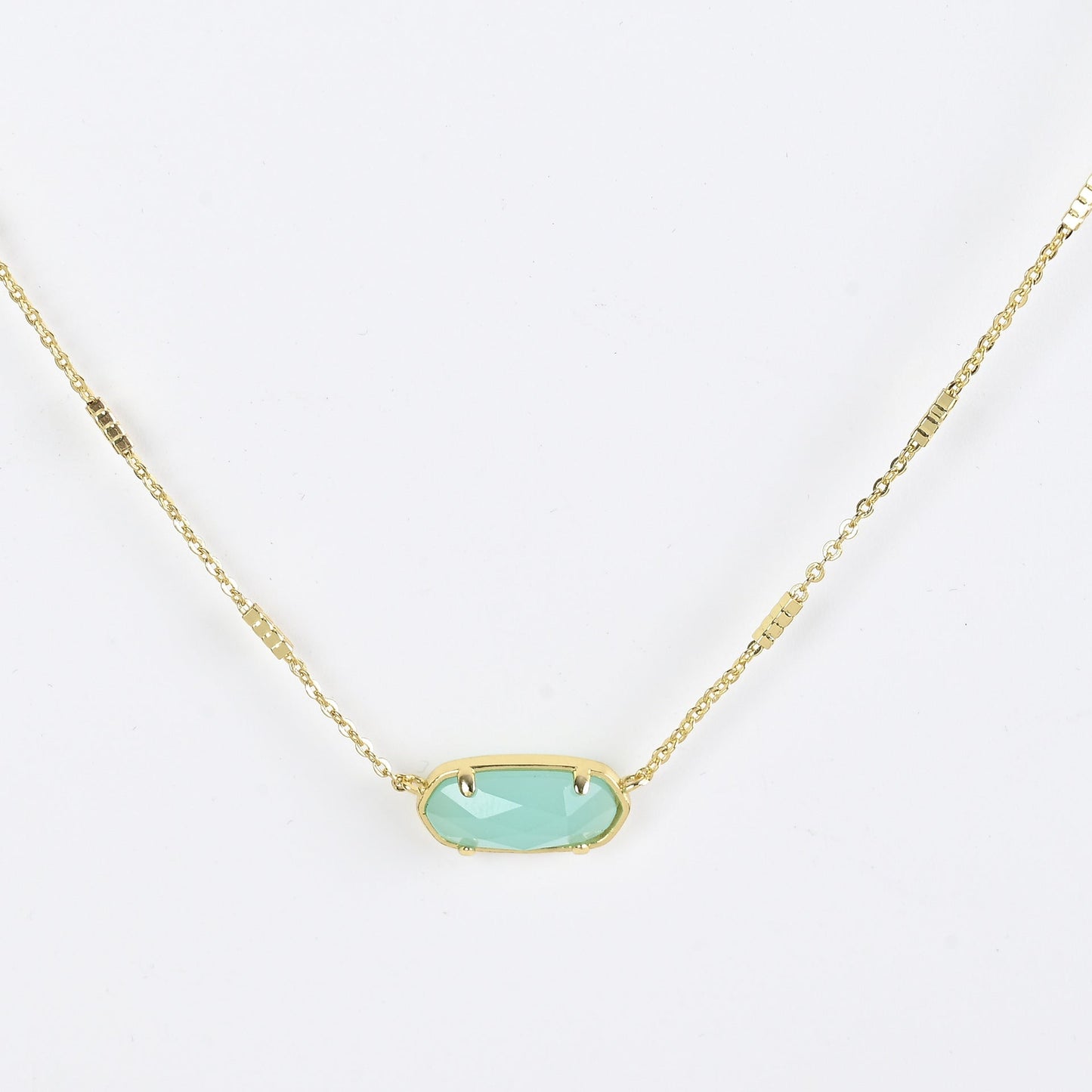 Oval crystal necklace with gold-tone chain and light blue oval stone