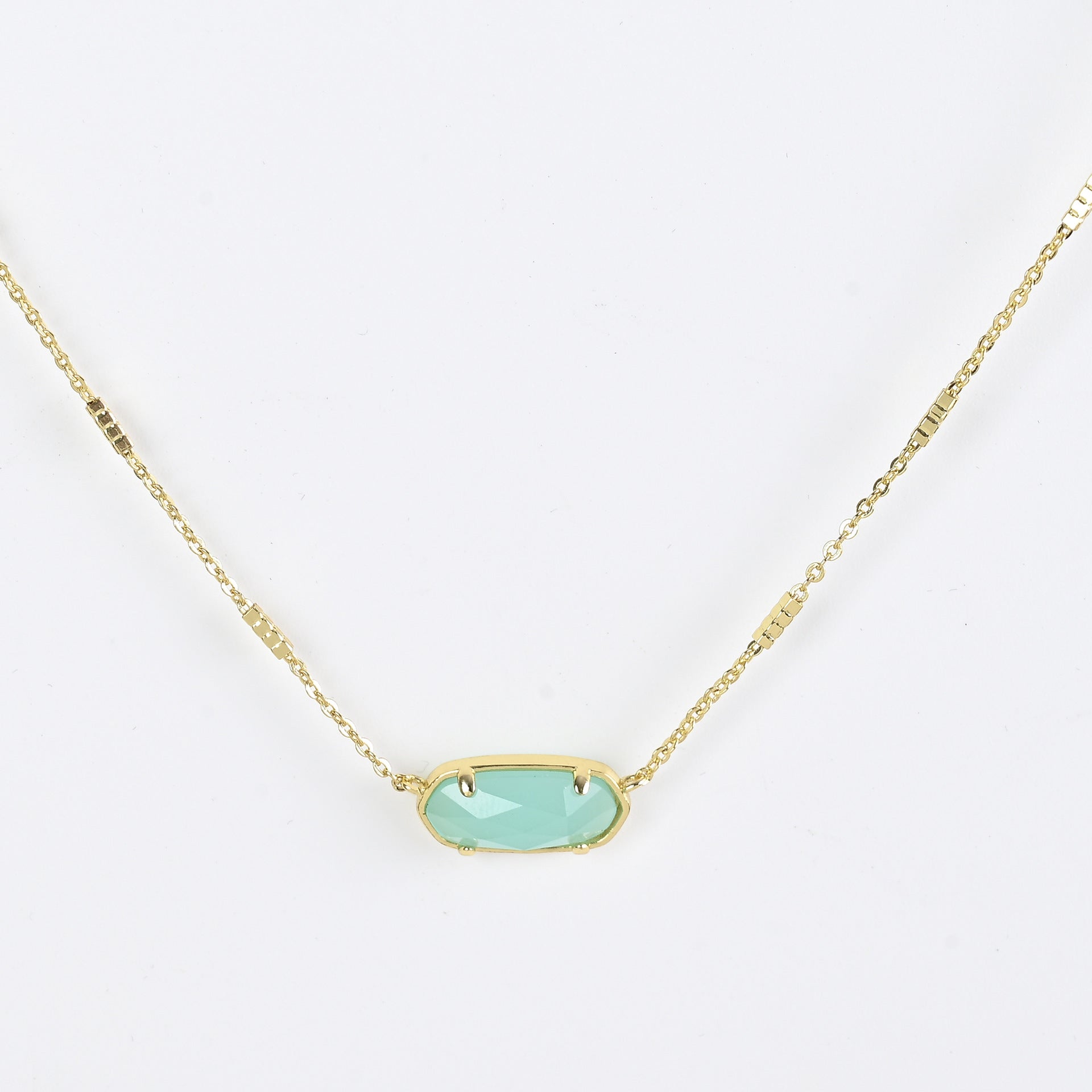 Oval crystal necklace with gold-tone chain and light blue oval stone