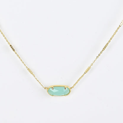 Oval crystal necklace with gold-tone chain and light blue oval stone