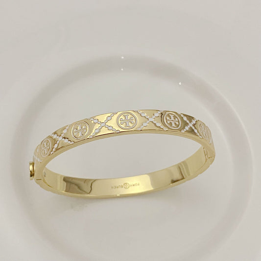 Tory Burch open metal cuff bangle, gold-tone with enamel logo medallions
