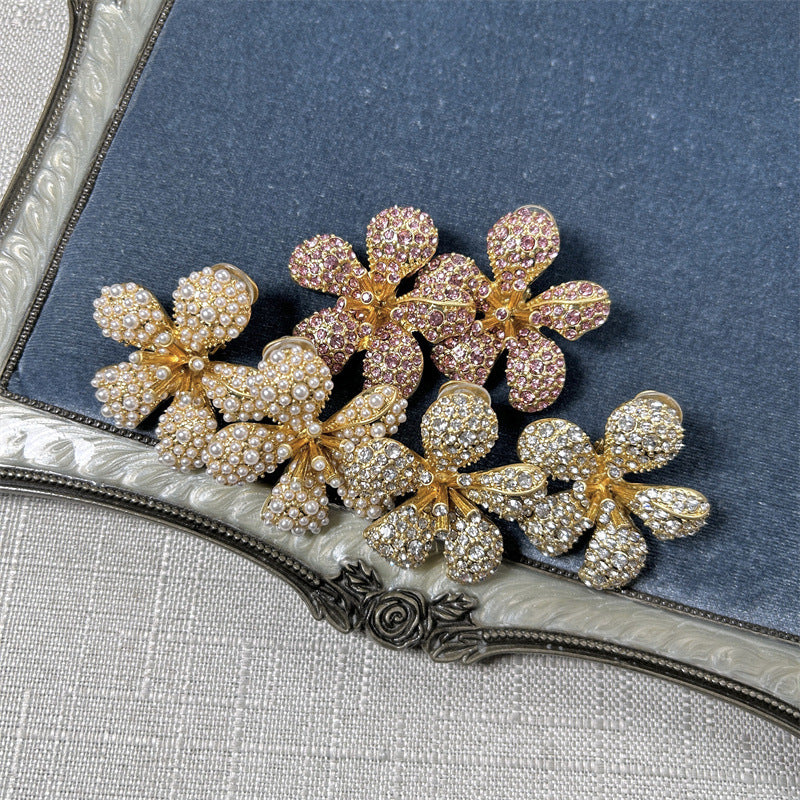 Five-petal flower clip-on earrings with white pearls and clear crystals on gold-tone setting