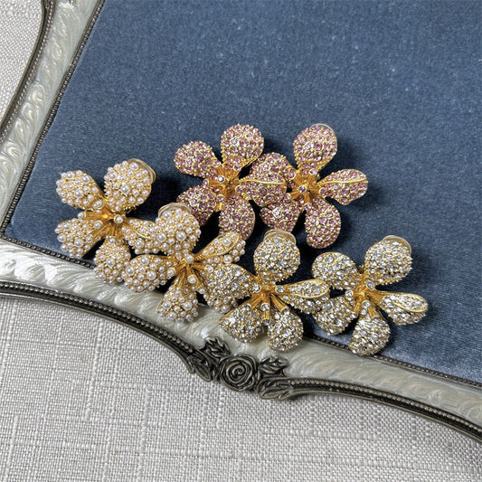 Five-petal flower clip-on earrings with white pearls and clear crystals on gold-tone setting
