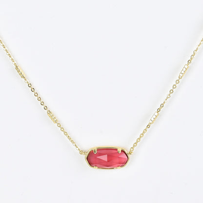 Oval crystal pendant necklace with pink stone and gold bezel on a gold chain