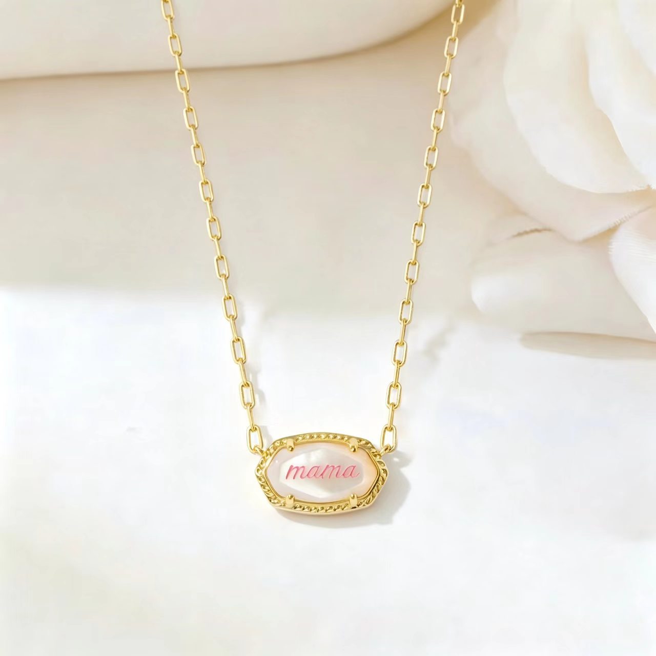 Gold necklace with long curb chain and oval “mama” pendant