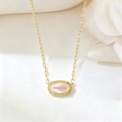 Gold necklace with long curb chain and oval “mama” pendant