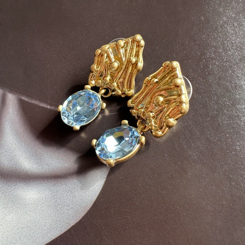 Gold-tone crystal drop earrings with oval blue stones
