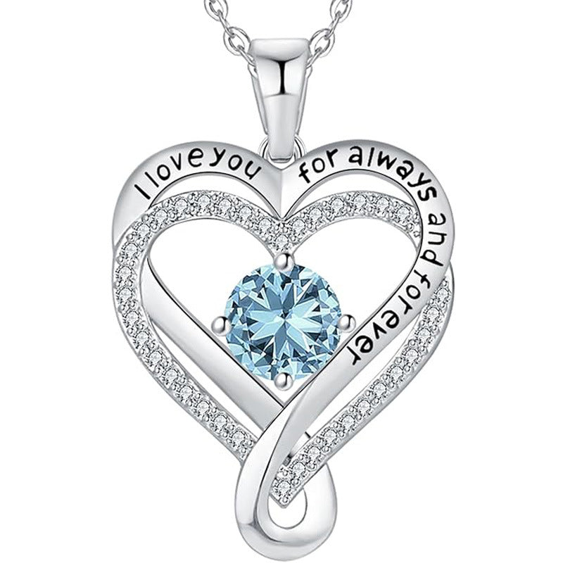 Silver heart pendant necklace with light blue round gemstone and pave heart frame