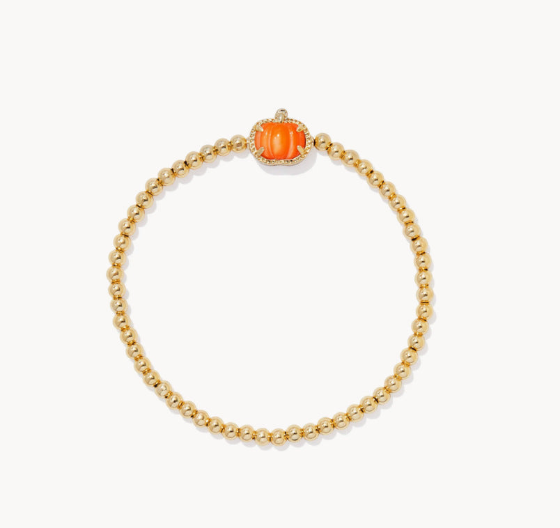 Gold beaded bracelet with orange pumpkin charm centerpiece