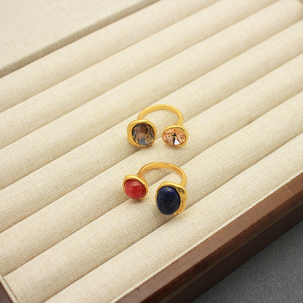 Adjustable open band gemstone ring with oval blue, red, and gold-tone stones