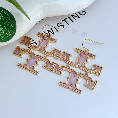 Acrylic logo drop earrings with gold-tone hooks and purple cutout letters