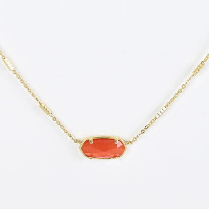 Oval crystal necklace with gold-tone chain and red oval stone