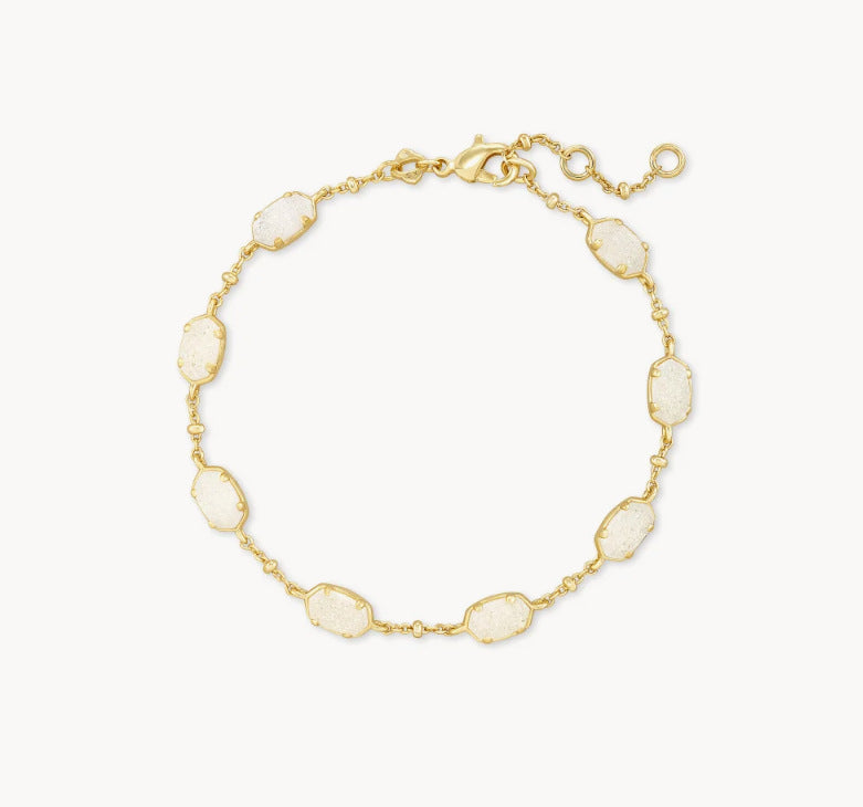 Adjustable chain bracelet with gold-tone links and faceted white crystal-like stations.