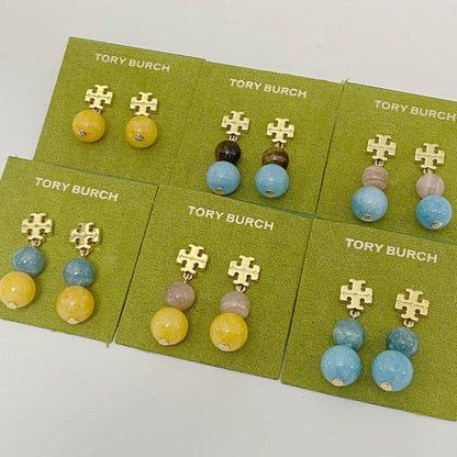 Tory Burch logo pendant earrings with mixed colored round agate beads on card