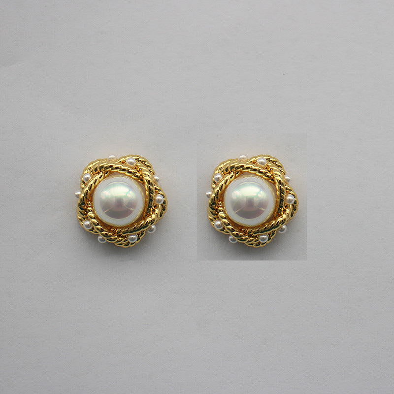Gold-tone round pearl stud earrings with braided halo and white-luster center pearl