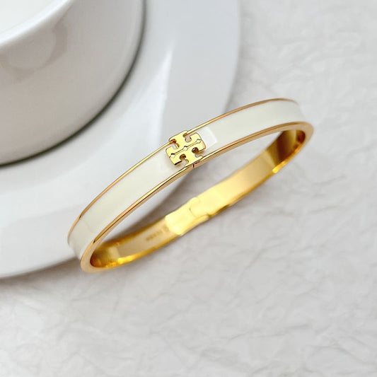 Tory Burch enamel metal bangle, white enamel with gold logo detail