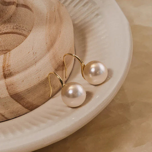 Round pearl hook earrings with gold-tone setting and two white round pearls