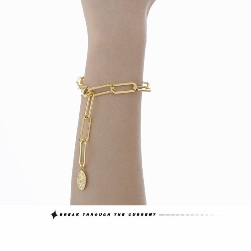 Trendy Gold Link Bracelet with Saint Charm

