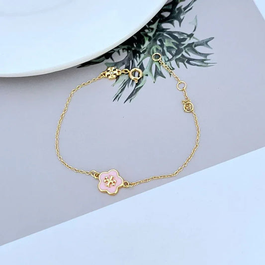 Gold-tone bracelet with pink enamel flower charm and small link chain