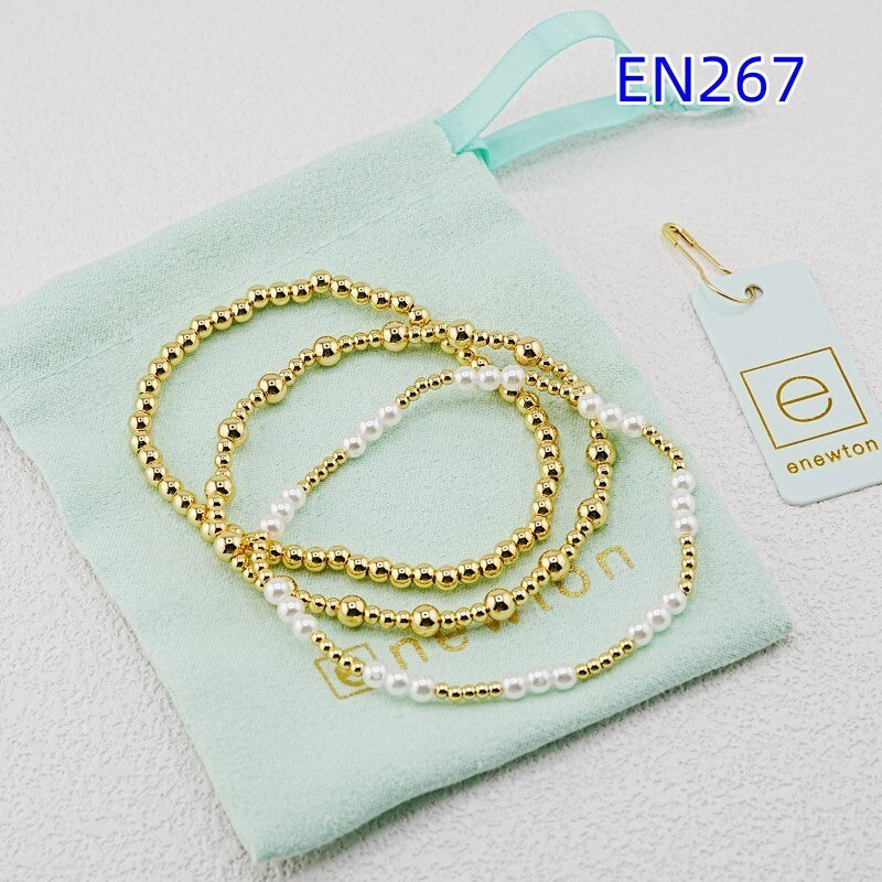 Three-piece gold beaded bracelet set with white pearl accents
