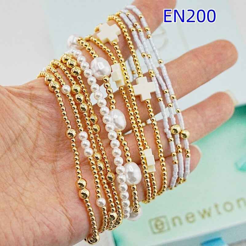 enewton 12-piece set of gold and white pearl bracelets
