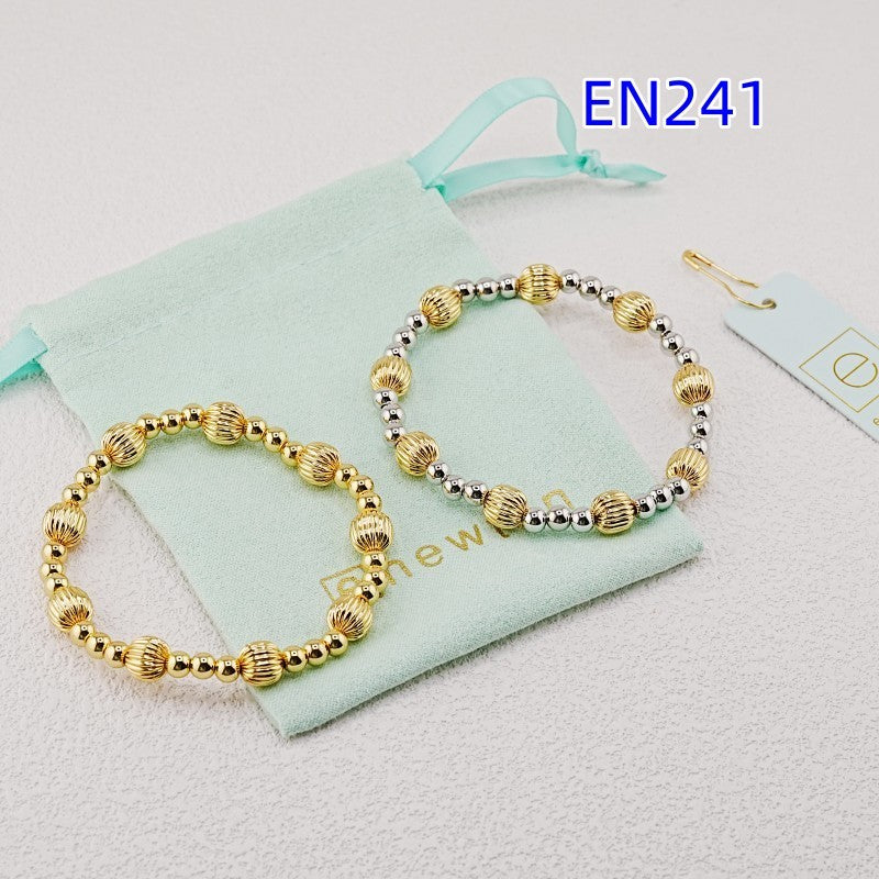 Two elastic bead bracelets, gold and gold-silver, with ridged oval and round beads