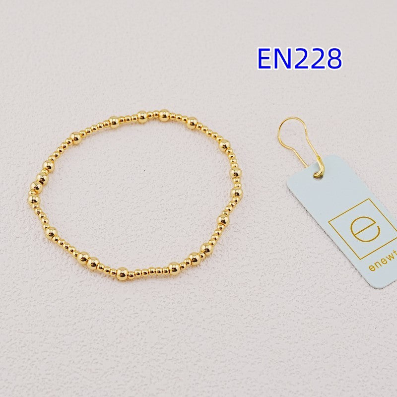 Gold beaded metal bracelet with round bead link design