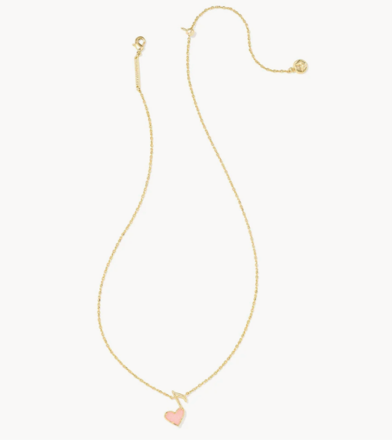 Gold-tone pendant necklace with a small pink heart charm on the chain